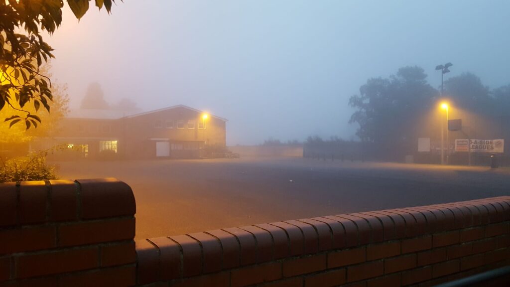 An image across the secondary school playground in early morning fog