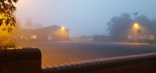 An image across a secondary school playground in early morning fog